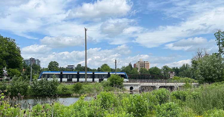 A landscape picture of an ION train in Waterloo Park