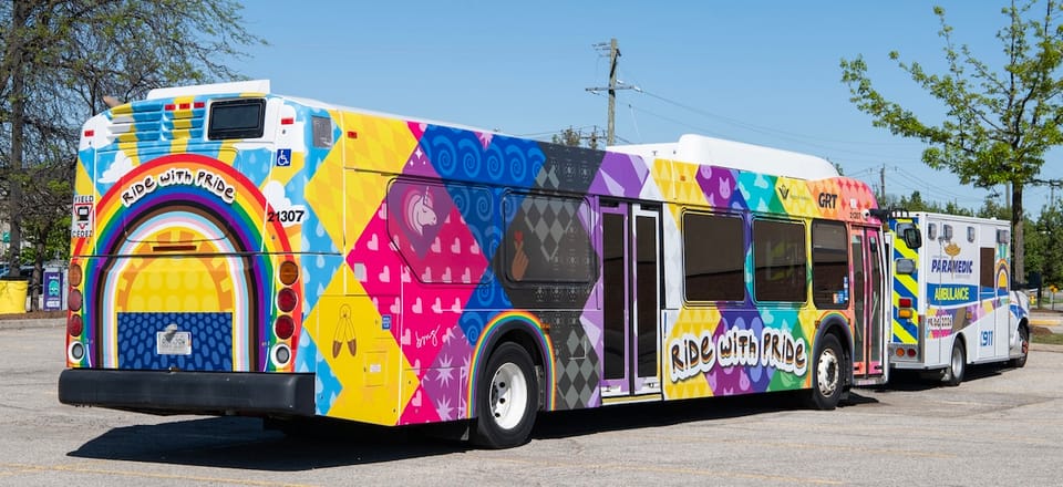Colourful wrapped GRT bus with rainbows and Ride With Pride branding